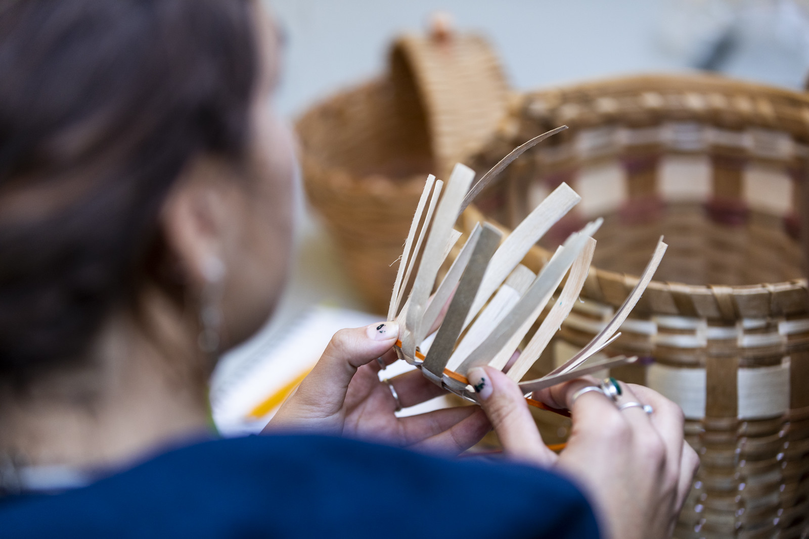 Woman weaving a basket